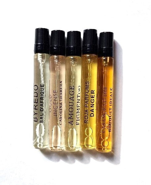 Set of five perfume bottles with visible brand names on a white background